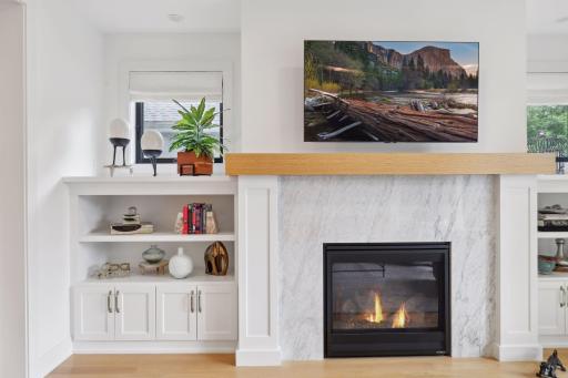Marble gas fireplace surround and white oak mantle.