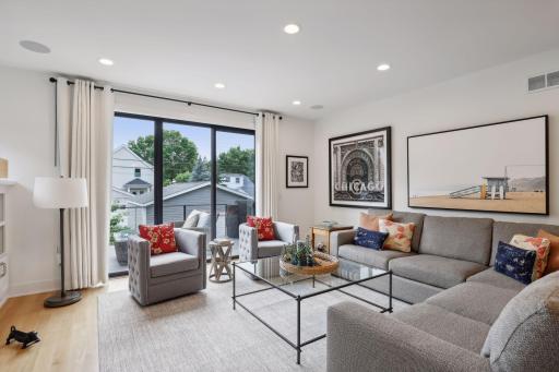 Gorgeous main level living room with floor to ceiling Marvin sliding glass doors leading to back deck.