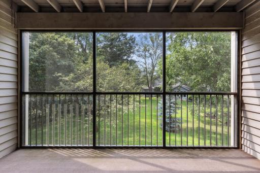Enjoy the quiet and beautiful view from the screened porch off the living room.