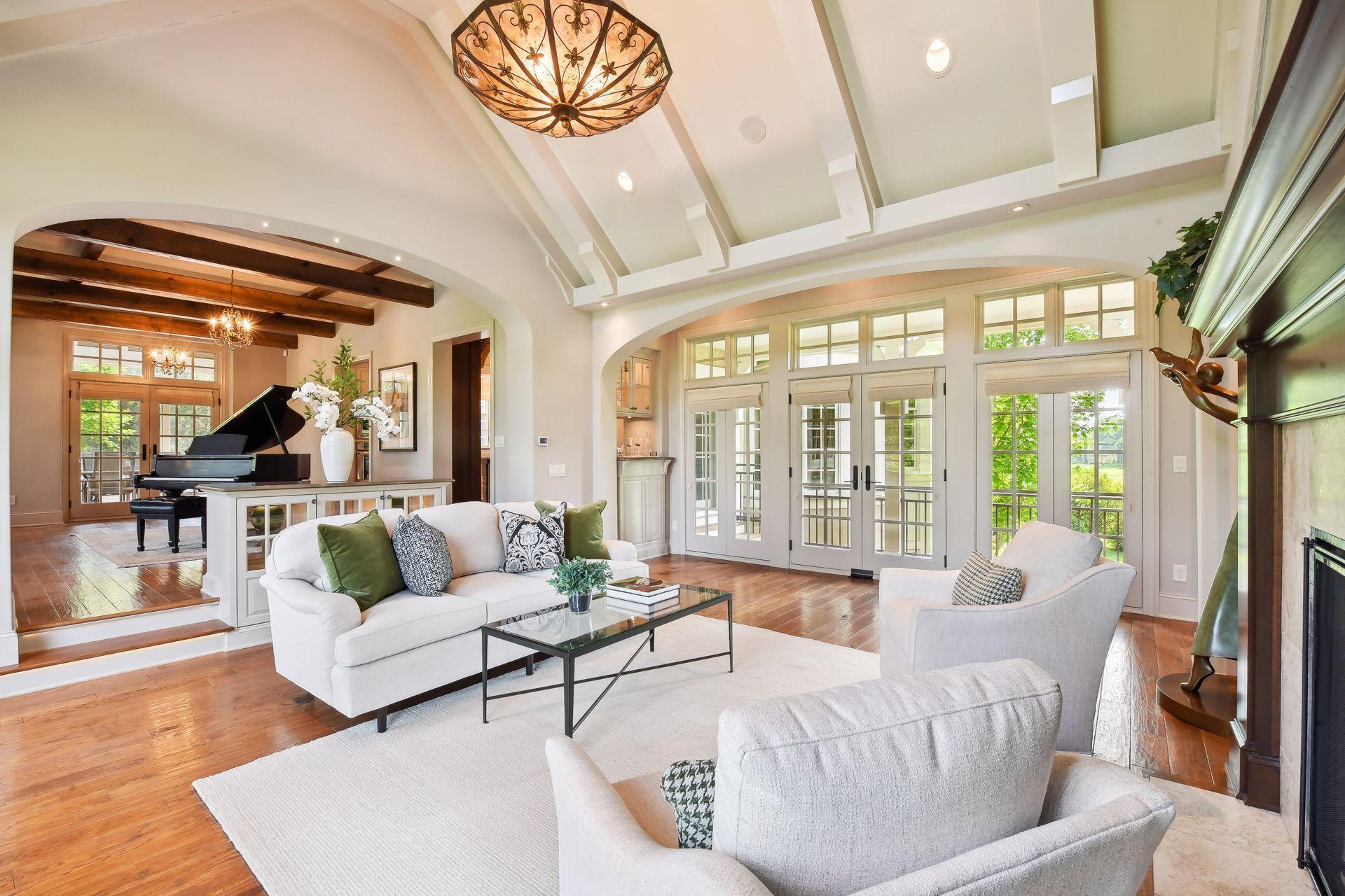 Gleaming wide-planked hardwood floors throughout the main level, custom beams, vaulted ceiling, arched pass ways, and beautiful lighting throughout are just a few of the thoughtful design details of this home