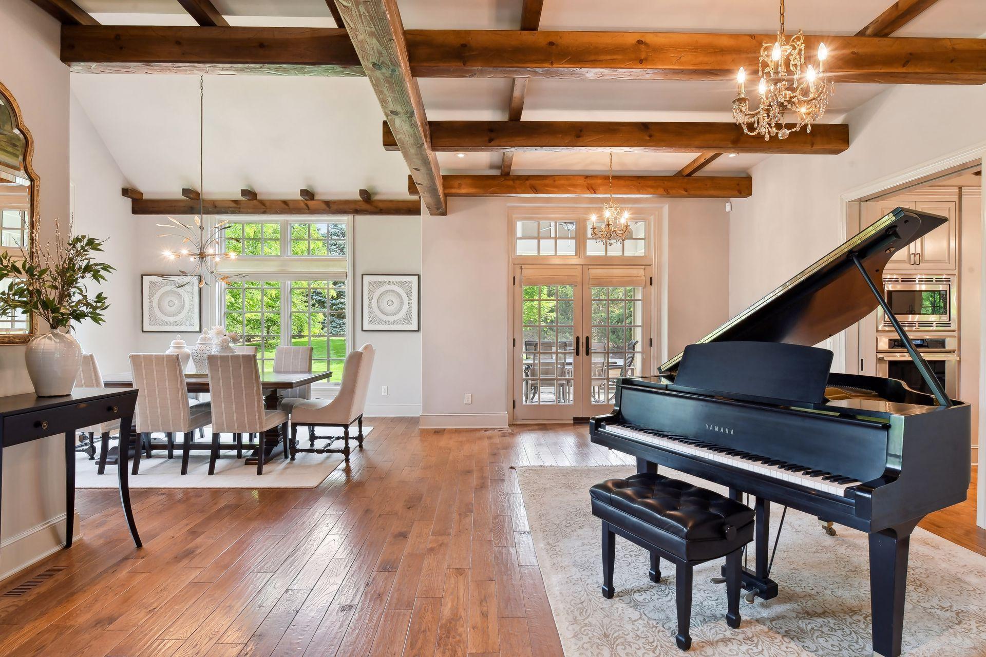 Custom beams on the ceiling add rustic interest and warmth to this grand foyer