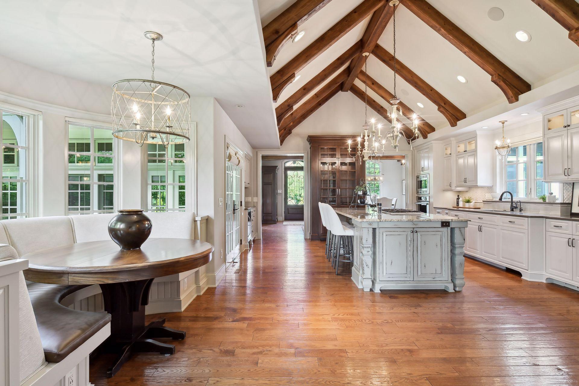The beautiful wood floors and wood beams continue through from the formal areas into this warm and inviting kitchen