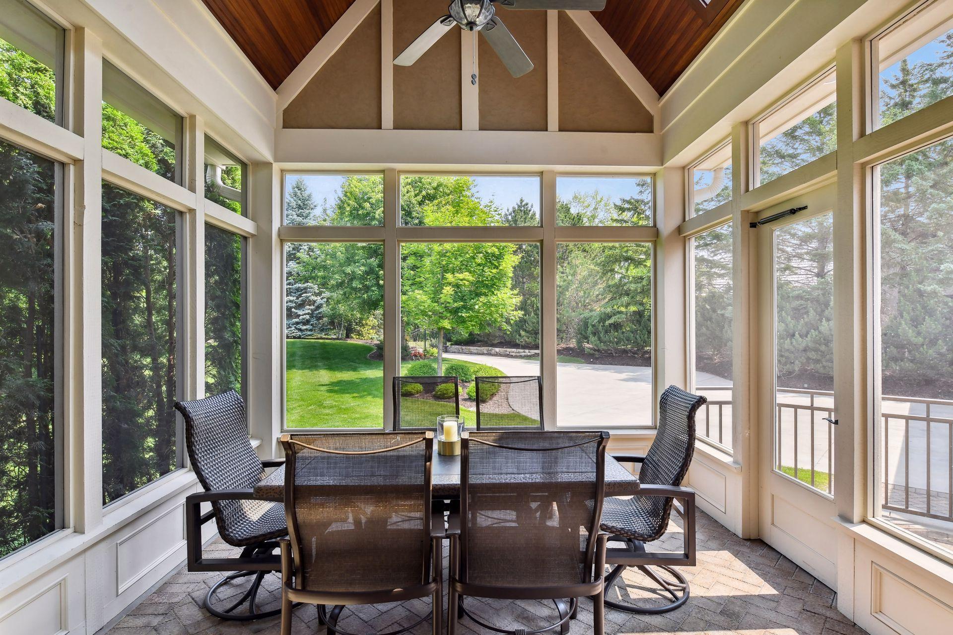 A casual screen porch off the formal dining area offers an intimate location for al fresco meals