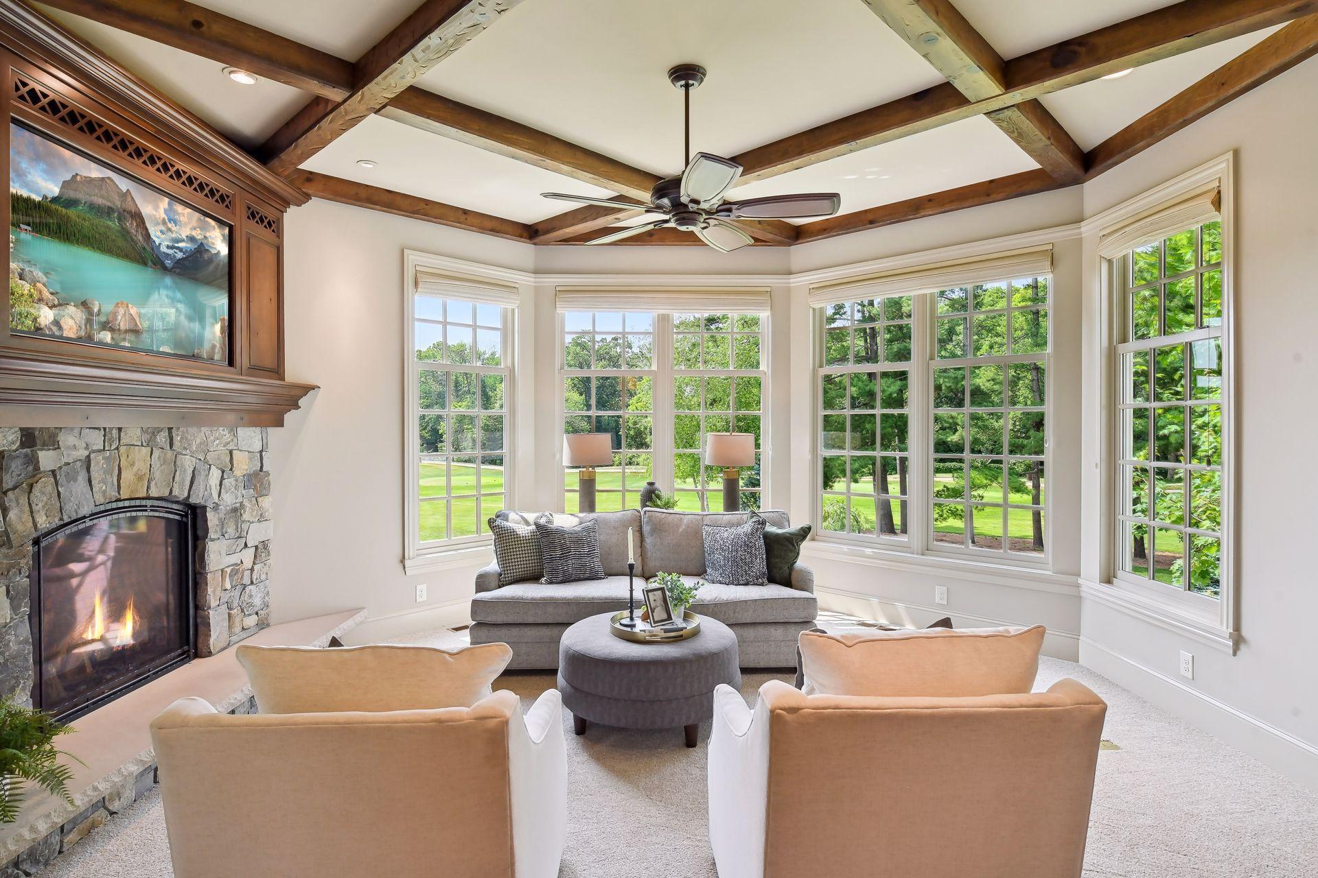 Rustic beams, cozy gas fireplace, and views of the golf course are highlights of this light-filled space