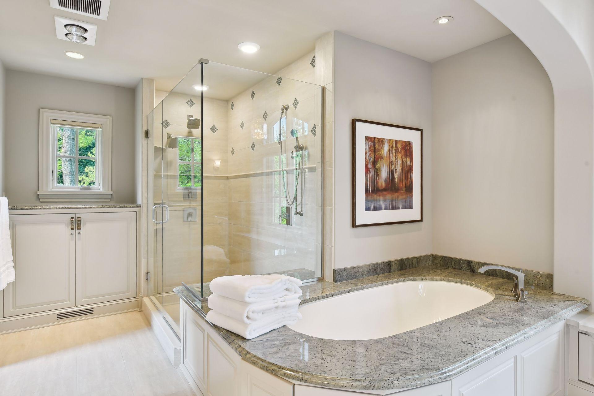 Relax and unwind in the large soaker tub or spacious shower space with multiple shower heads
