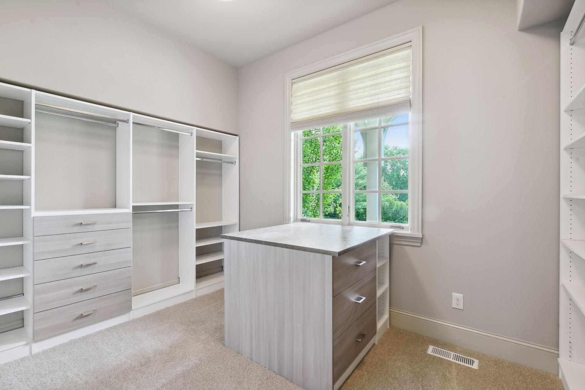 Large walk-in closet with built-in organizational components