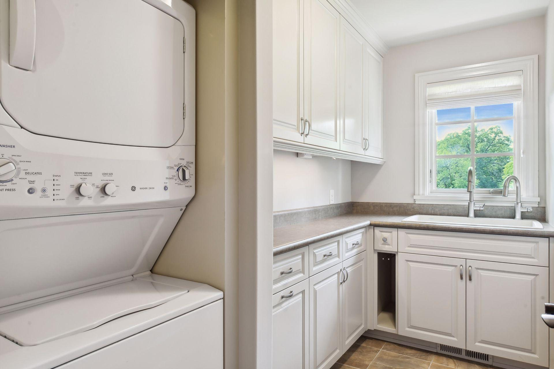 This laundry is located in the back hall, with additional laundry units found in the owner's suite and lower level