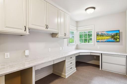 A spacious private home office space is located off the main level back hall entry