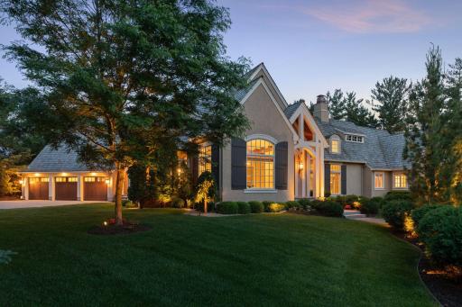Decorative landscape lighting throughout the property adds to the refined nighttime ambiance