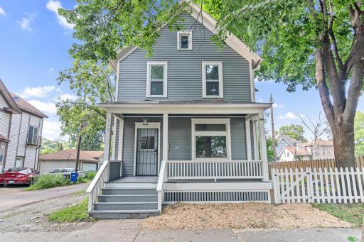 Charming exterior with front porch and white picket fence