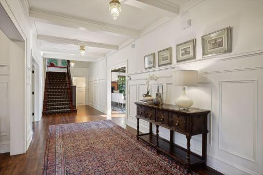 Welcoming front entry hall with freshly painted walls and gorgeous enameled wainscoting.