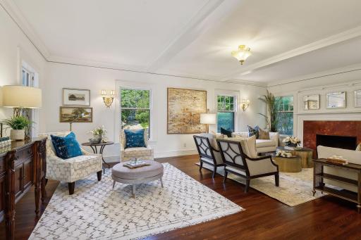 Spacious formal living room with wood-burning fireplace.