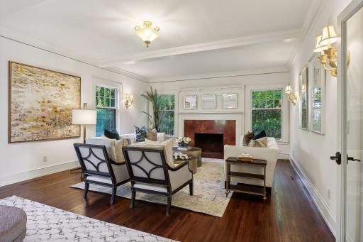 Spacious formal living room with wood-burning fireplace.