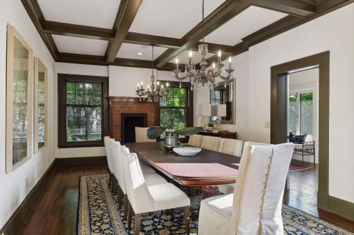 Decorative fireplace with tile surround and adjacent walk through butler's pantry leads to kitchen.