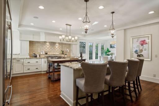 Countertop seating with prep sink and service area in addition to the center island and informal dining area. A kitchen designed with a chef and entertainer in mind.