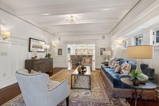 The spacious family room is conveniently located next to the kitchen. Beautiful enameled woodwork, wainscoting, and beamed ceiling.
