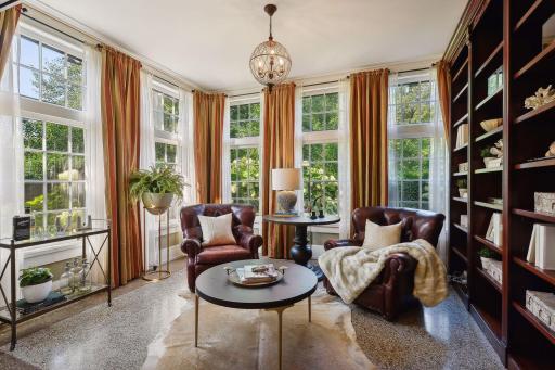 Library with terrazzo floors, built-in bookshelves, wonderful natural light, and views of the garden. A perfect spot to curl up with a book.