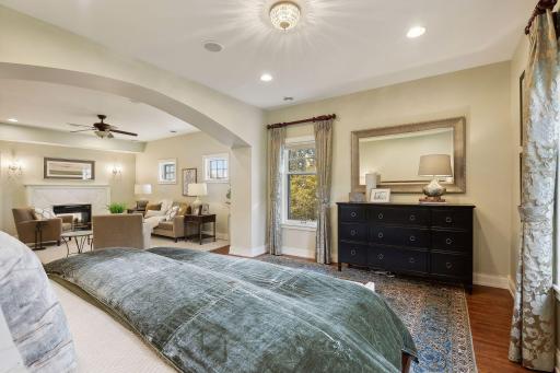 The dreamy primary bedroom features its own sitting room with two-sided gas fireplace.