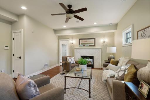 Primary bedroom sitting room with two-sided gas fireplace.