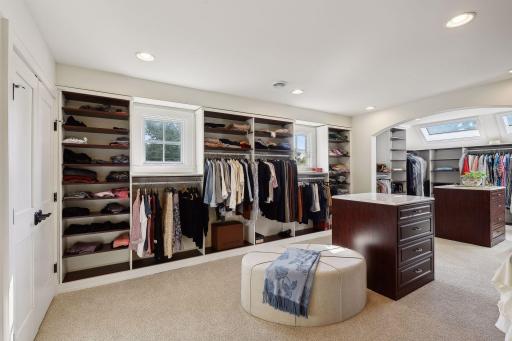 Enviable walk-in closet with two areas to meet all storage needs with display cabinetry, skylights, wonderful natural light, and a laundry closet dedicated to the primary suite in addition to a second level hall laundry.