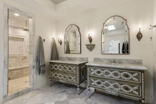 Heated marble floors and double vanities with storage. Large walk in shower with large bench, rain shower, and recessed shampoo shelf.