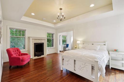 Generous 2nd bedroom with decorative fireplace, seating area, huge walk-in closet and en suite bathroom.
