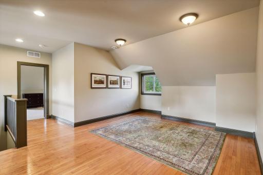 3rd floor with den, hardwood floors, 3/4 bath, 5th and 6th bedrooms, and a large bonus space with vaulted ceiling. Excellent expansion space for work, play, nanny, guests, caretaker, or multi-generational living.