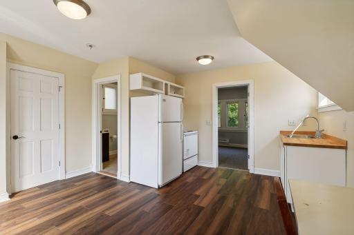 Carriage house apartment above 2-car detached garage with 3/4 bathroom, kitchenette, sitting area, bedroom, storage, and separate HVAC system.