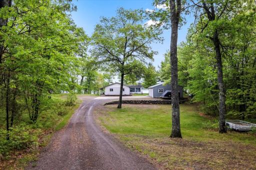 house is set back amongst mature trees for privacy