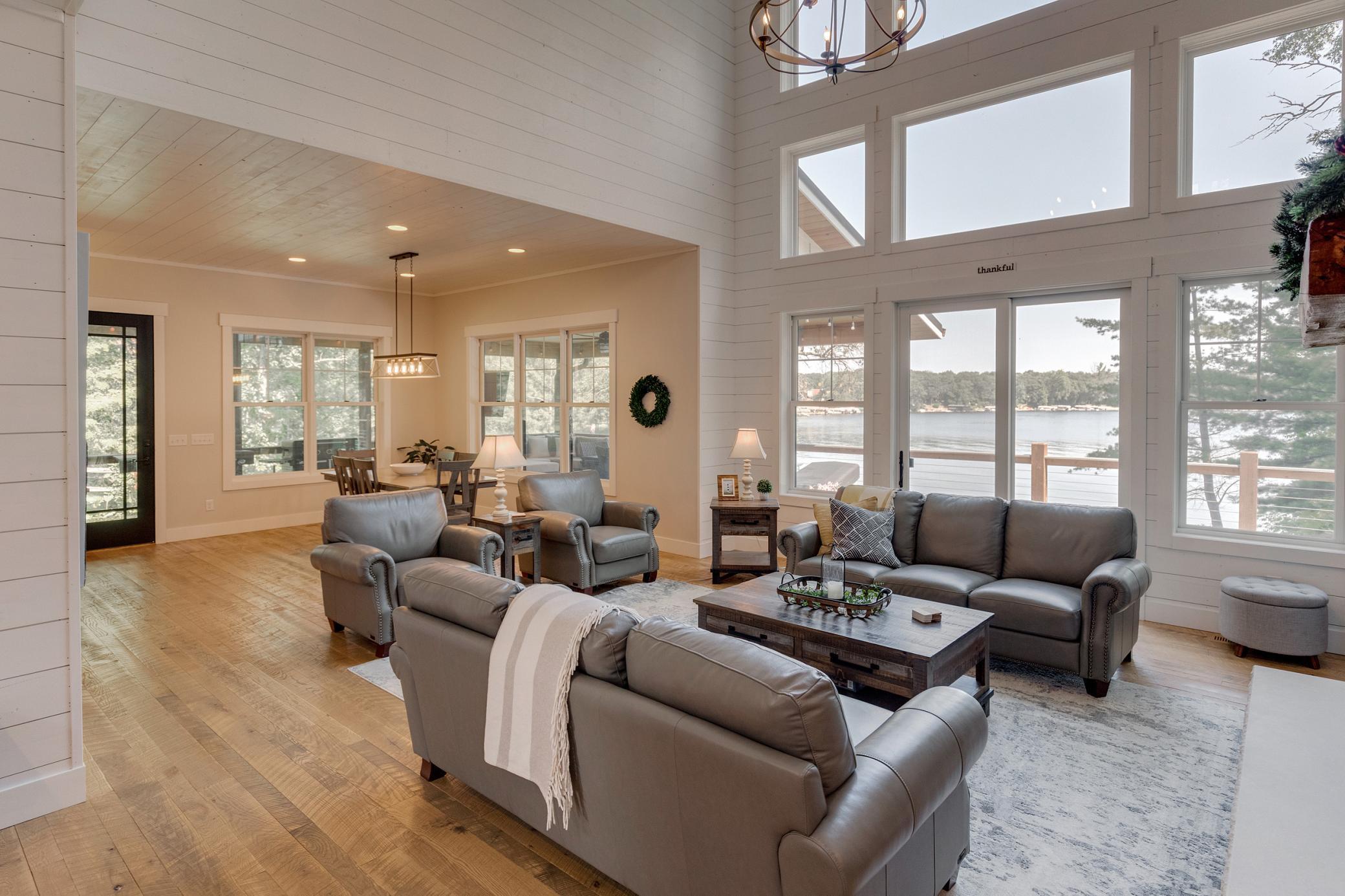 Main level great room with lake views and a fire place