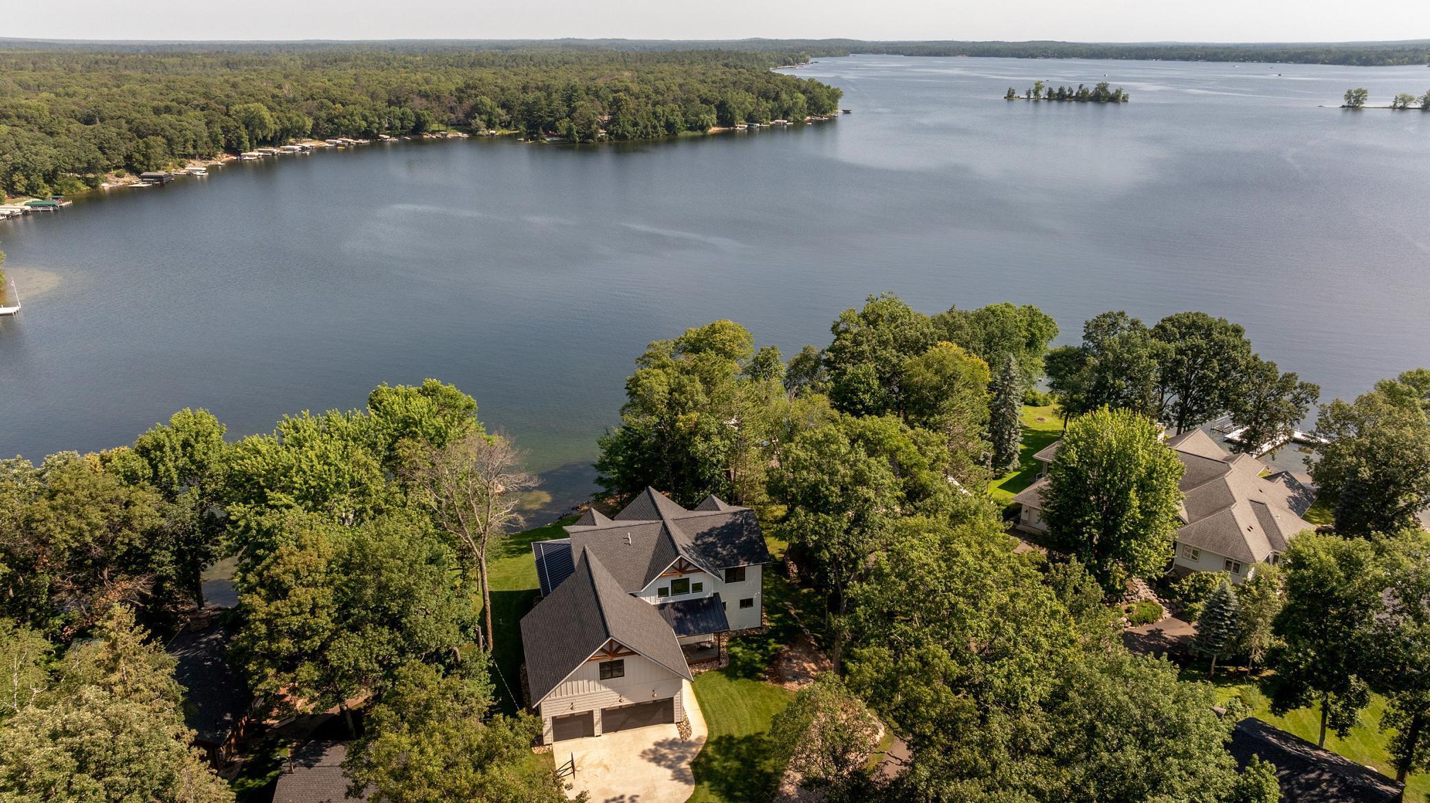 Aerial photos illustrating a luxury two story overlooking the lustrous Cross Lake.