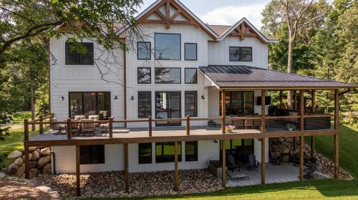 Waterfront Two Story with partially covered warp around deck.