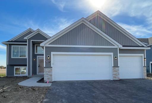 9837 32nd St NE- Home features stone accents, unfinished walkout lower level, and Pella windows. Sod, Irrigation system, and front yard landscaping included.