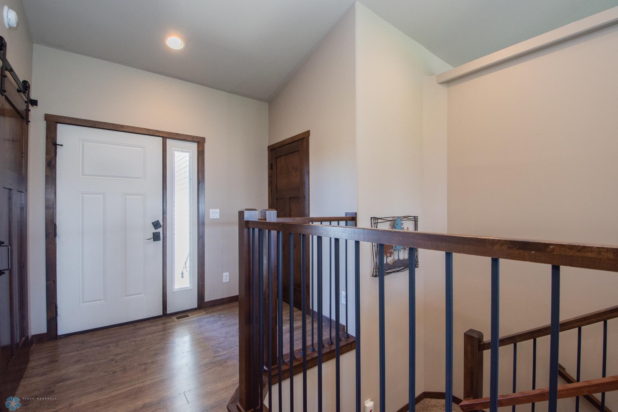 Foyer with walk-through closet to garage entry access