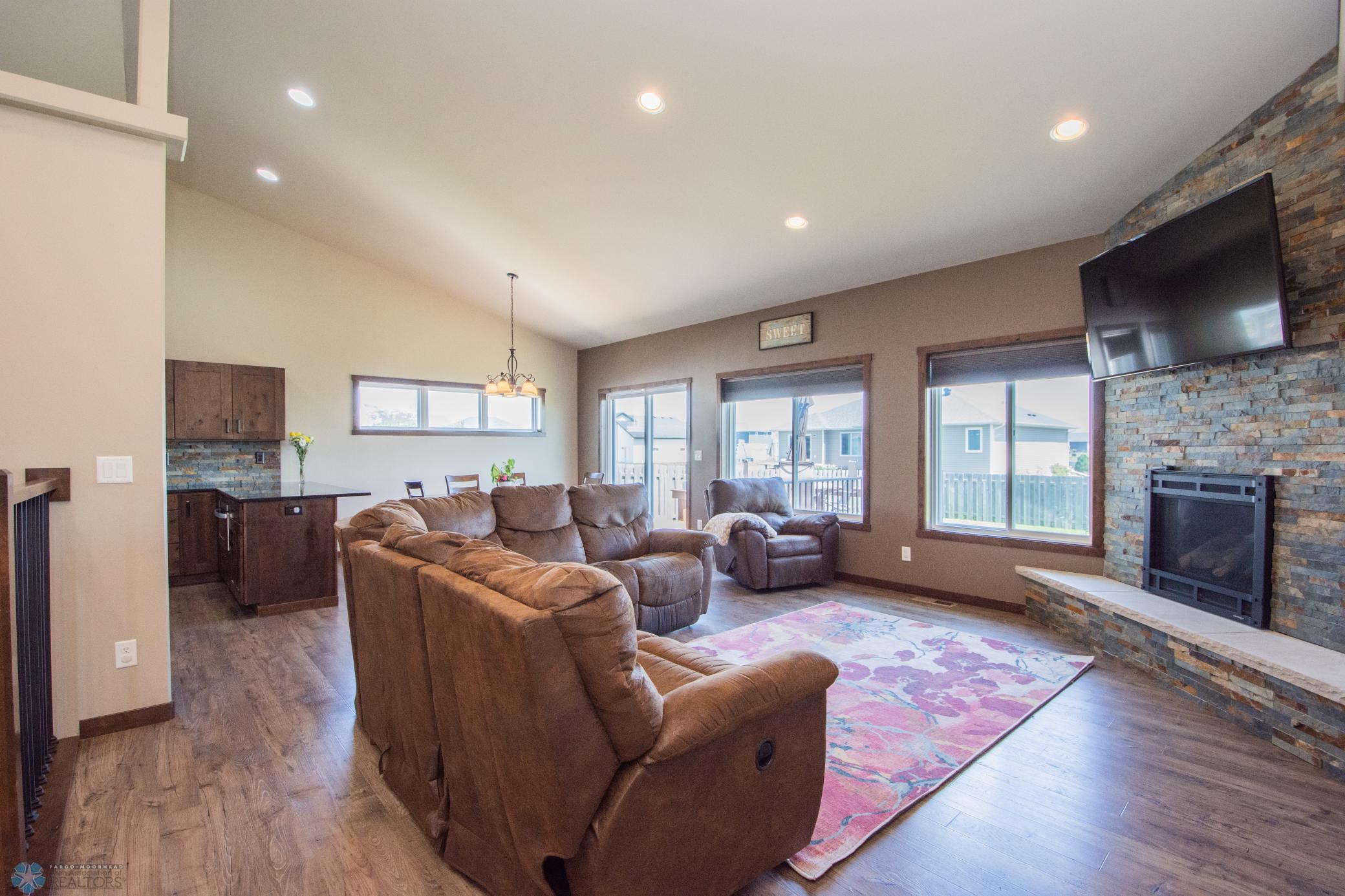 Bright & Open Living Area on Main floor with gas fireplace and beautiful stone surround
