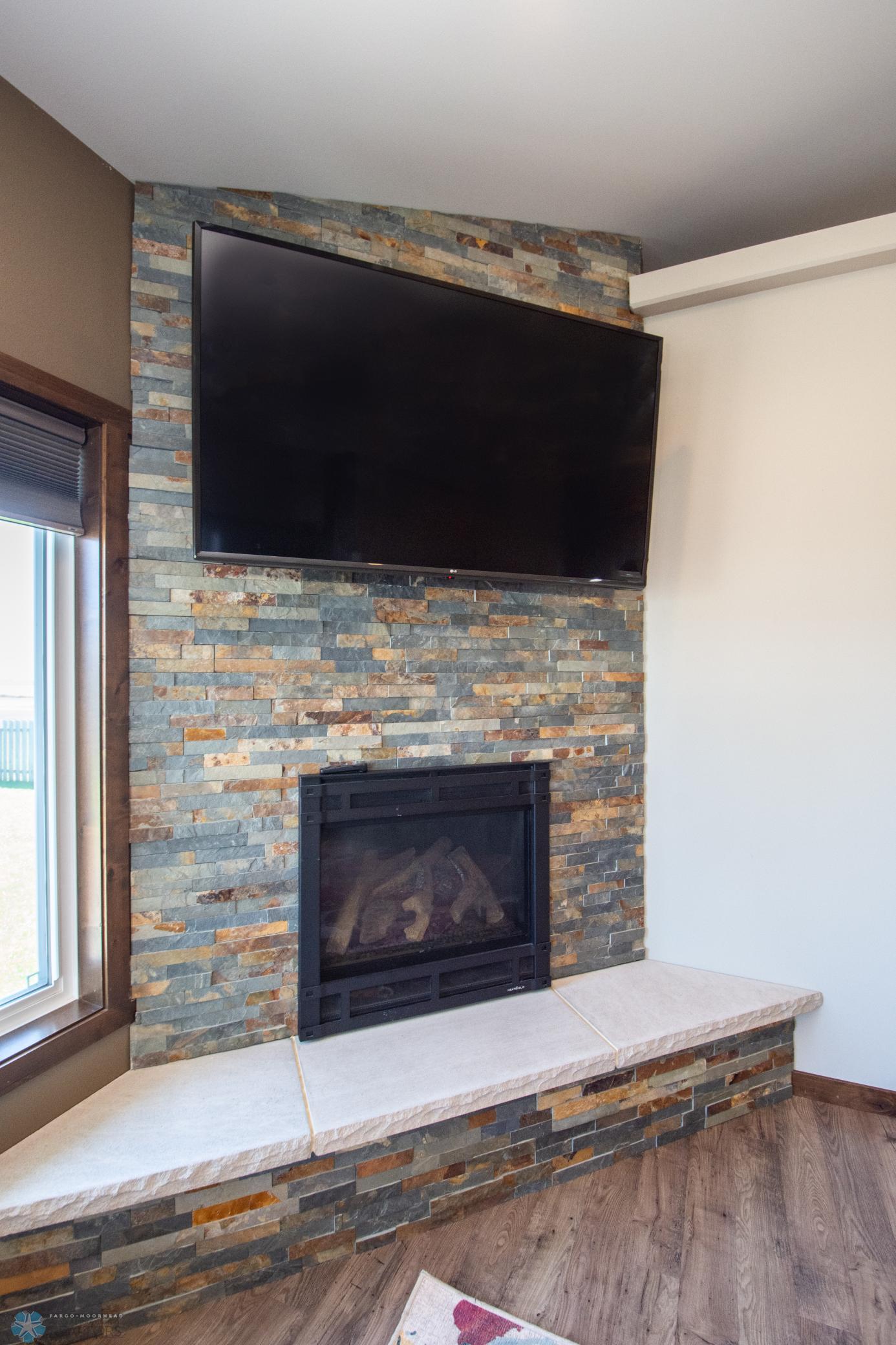 Beautiful gas fireplace with stone surround