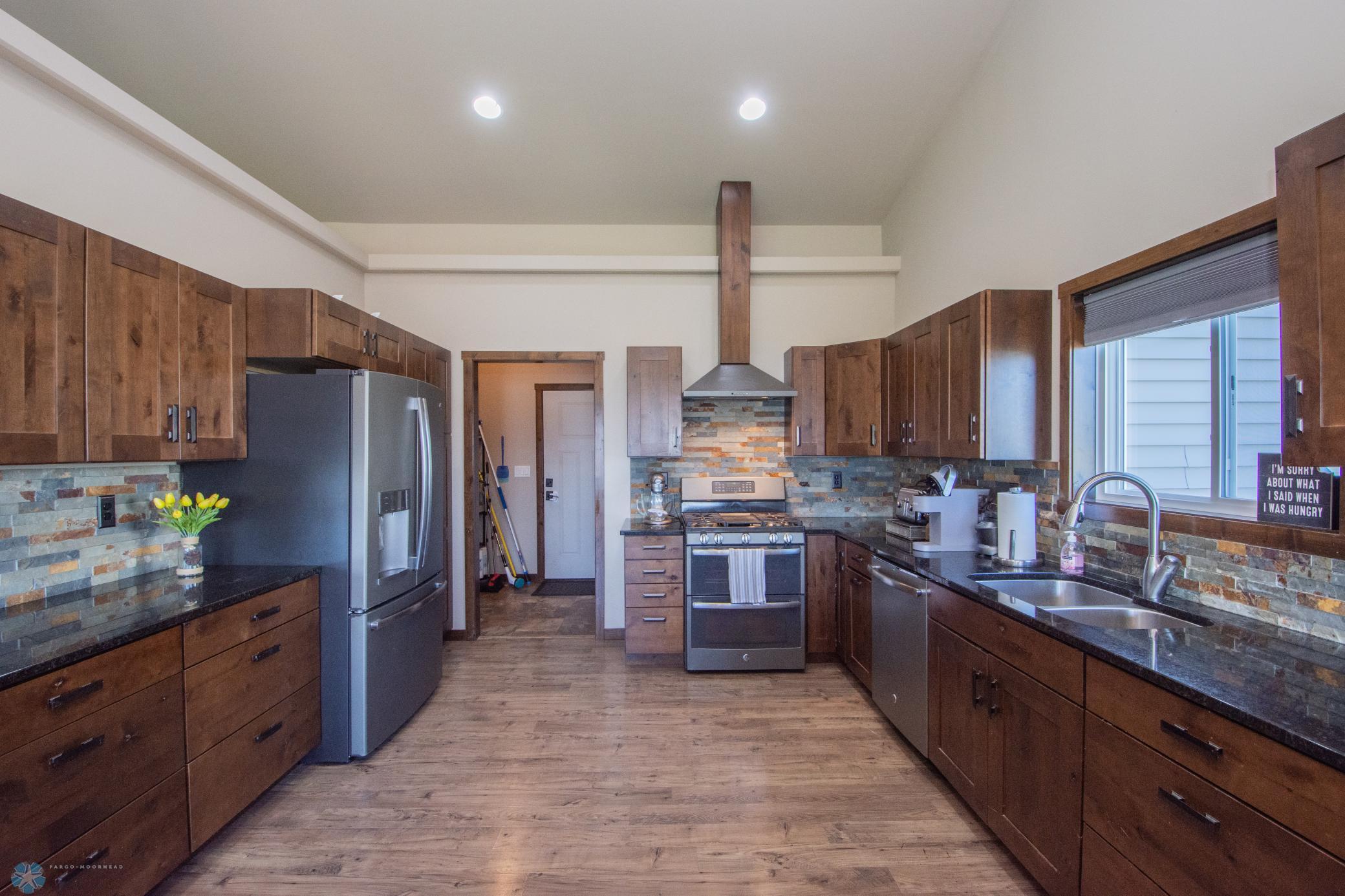 Spacious Kitchen with SS Appliances including gas stove! Granite tops; Lots of storage!!