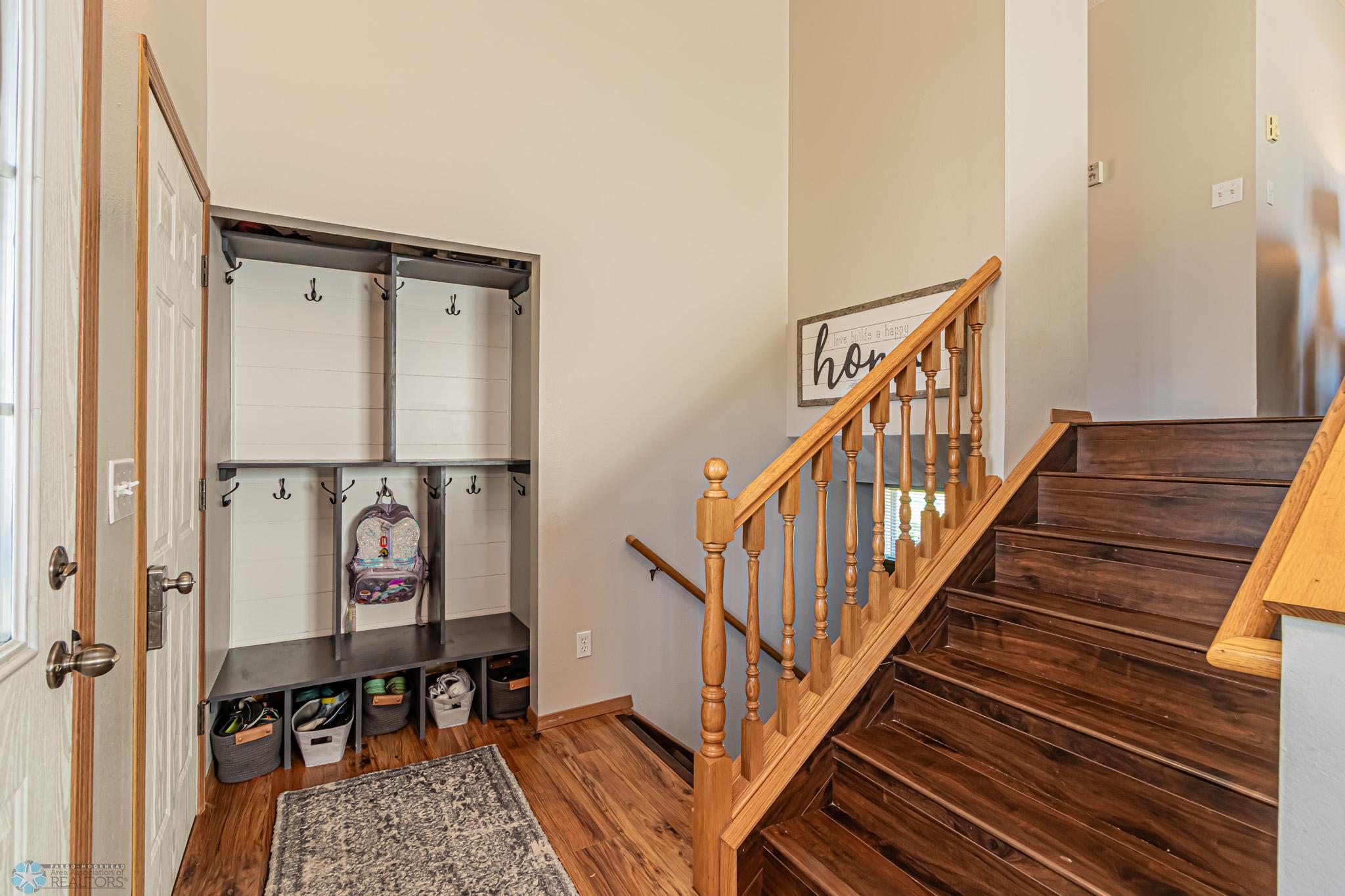 Entry area with Cubbies; added beautiful wood stairway