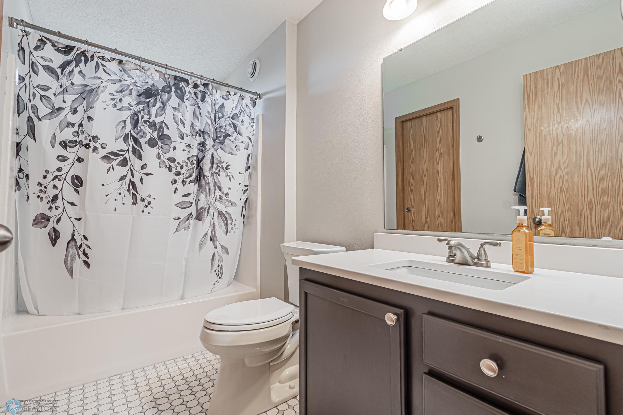 Hollywood Bath - Added Quartz Countertop & Tiled Flooring