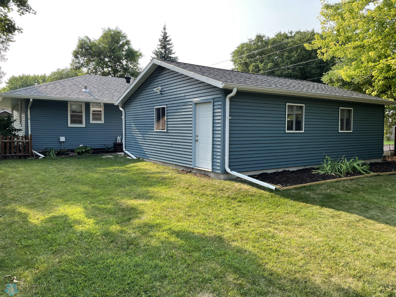 Backyard view to house and garage.png