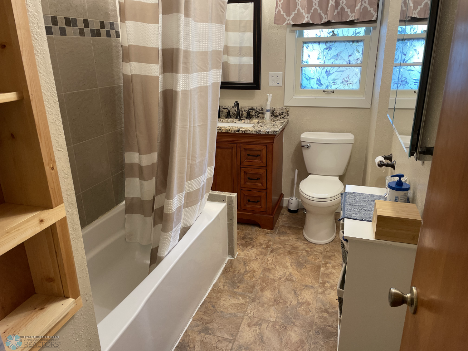 Main floor full bath with tile shower walls and and floor.png