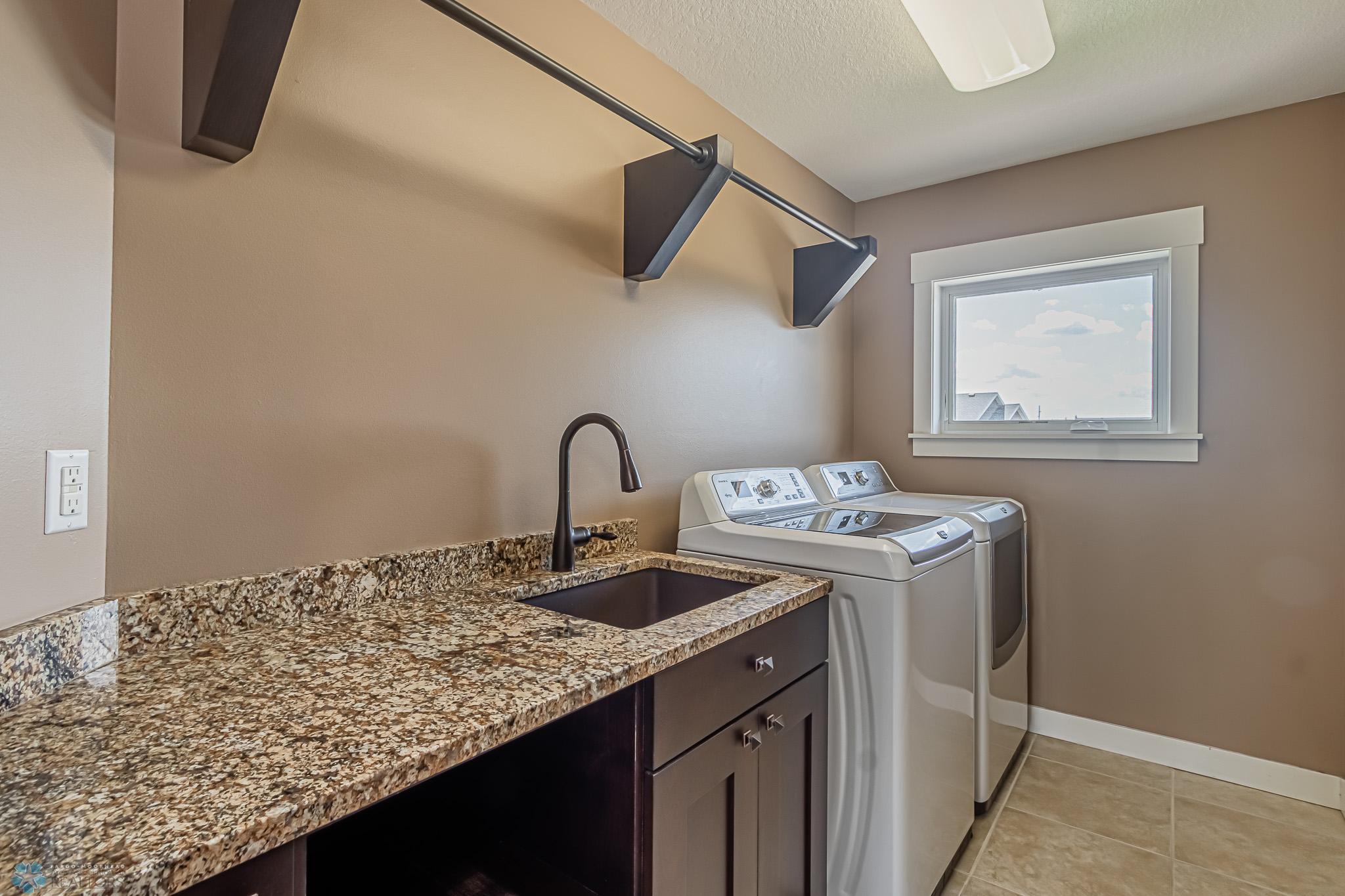 2nd Story Laundry Room with laundry sink, granite countertop & clothes hanging space - W/D included!