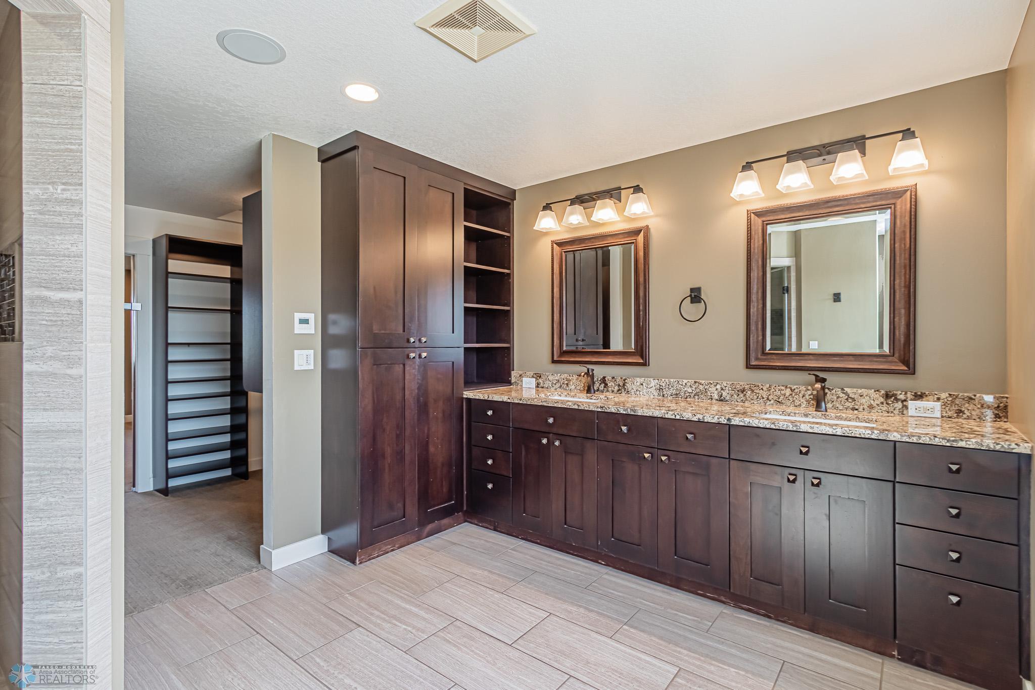 Primary bath with DBL sinks, heated tile floor, Custom Steam SHWR