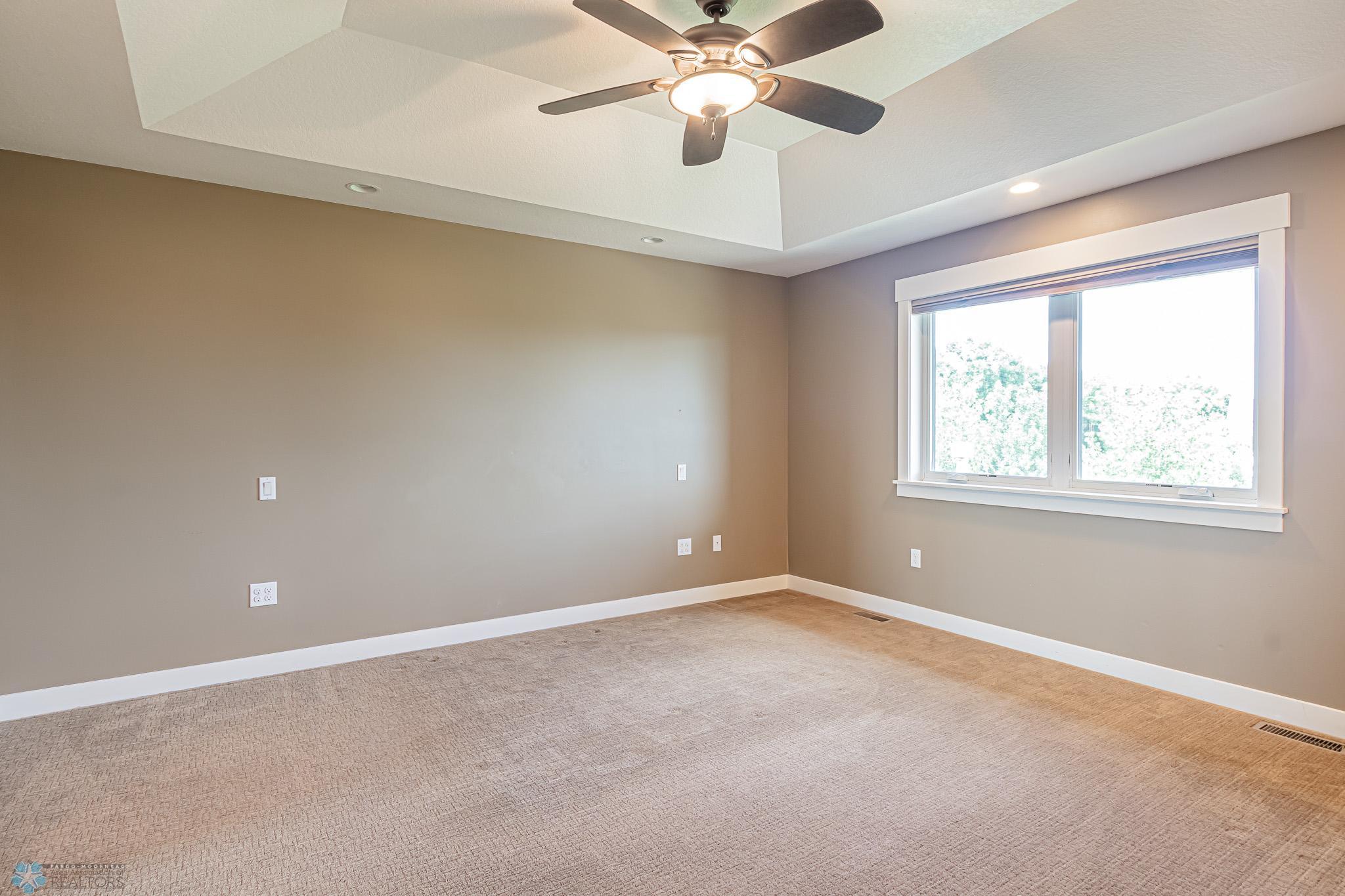Primary Bedroom Suite with RM darkening Hunter Douglas blinds, Trayed Ceiling, Ceiling fan, & WIC