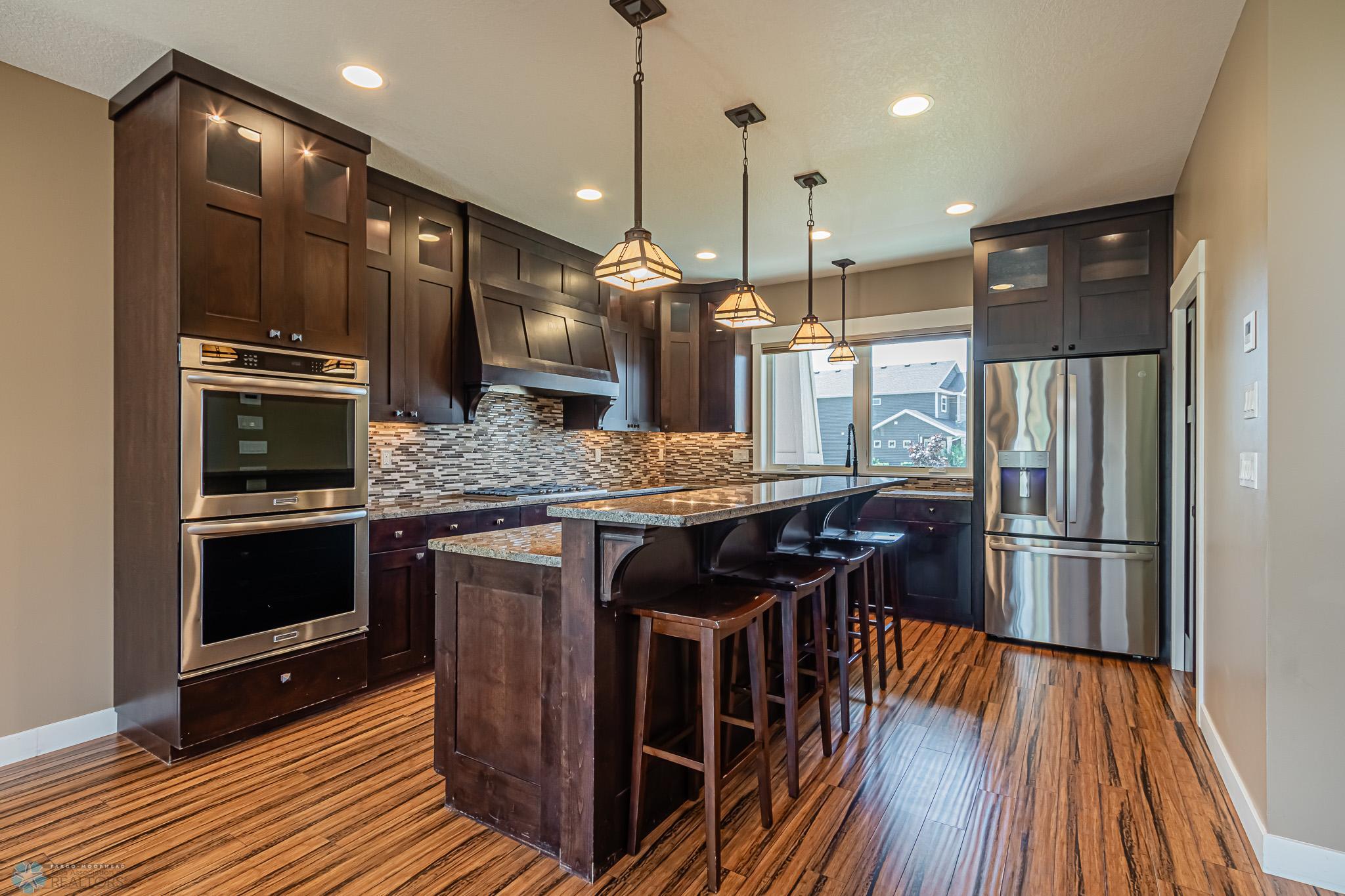 Dream Kitchen includes DBL Ovens, Exterior Vented 5-Burner Gas Range, Drawer-style Micro, Granite Countertops, Under-Cabinet & Top-Cabinet Lighting & more!