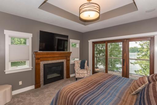 Primary bedroom fireplace and walk out deck