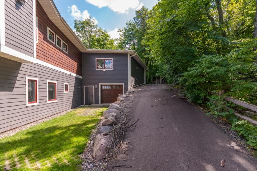 Outside entrance to tuck under garage with private drive down to the lake