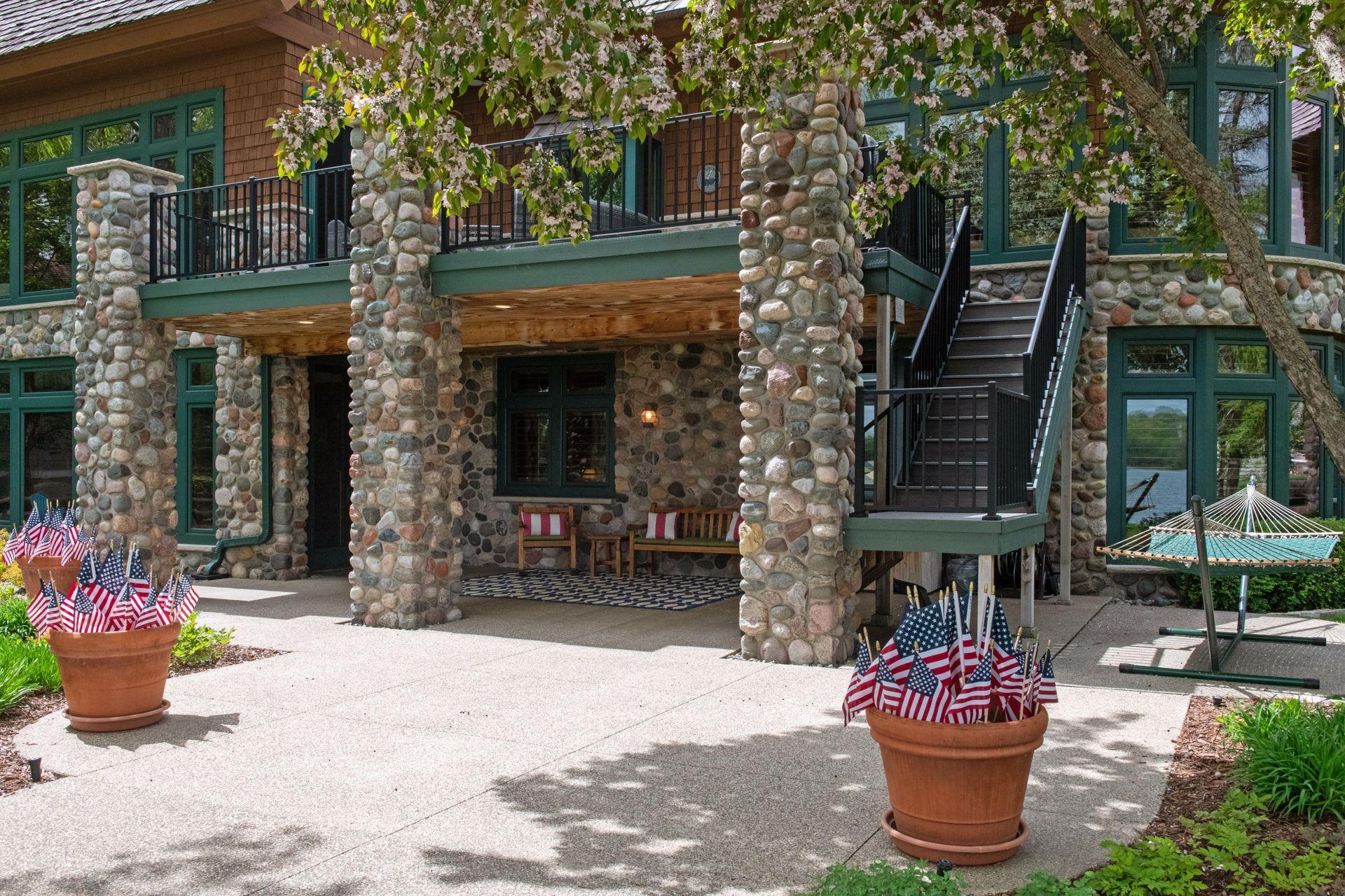 Stunning lower level covered patio complete with sound, recessed lighting / beach sconces along with staircase to deck and lower level garage door to the right not pictured.