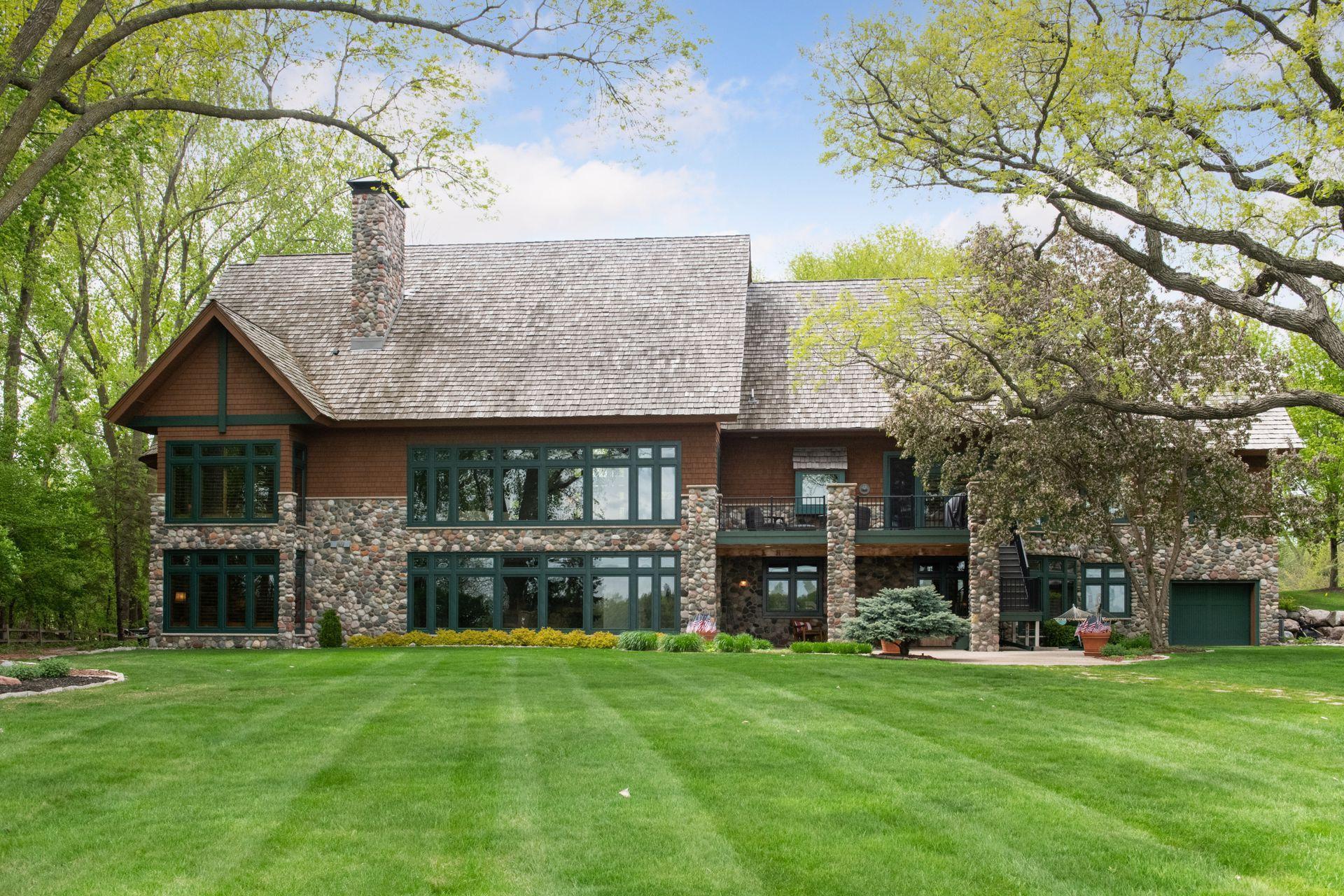 Stunning lake home showing the back of home, lower level patio, upper deck and all detail for 6941 Beach Road. Thank you for visiting this urban retreat.