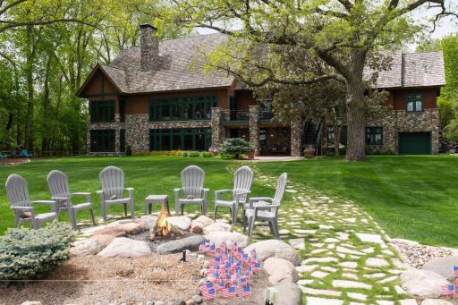 This level lakefront home has spacious flat backyard. It awaits you and your guests for endless fun.